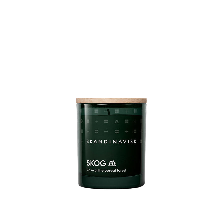 The Skandinavisk Mini Scented Candle Skog 20h, 65g features a calm boreal forest scent and a wooden lid, crafted from Swedish rapeseed wax. Shown against a plain white background.
