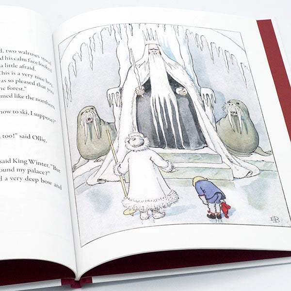 The "Ollie's Ski Trip Mini Edition Book" by Elsa Beskow features a snowy scene where two children meet King Winter, who sits on an icy throne flanked by walrus-like creatures, beautifully illustrated for young readers.