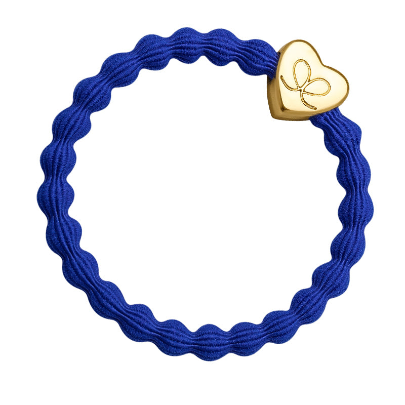 The ByEloise Bangle Band in Royal Blue features a wavy elastic design with a gold heart charm—ideal as a cute bracelet or a stylish hairband.