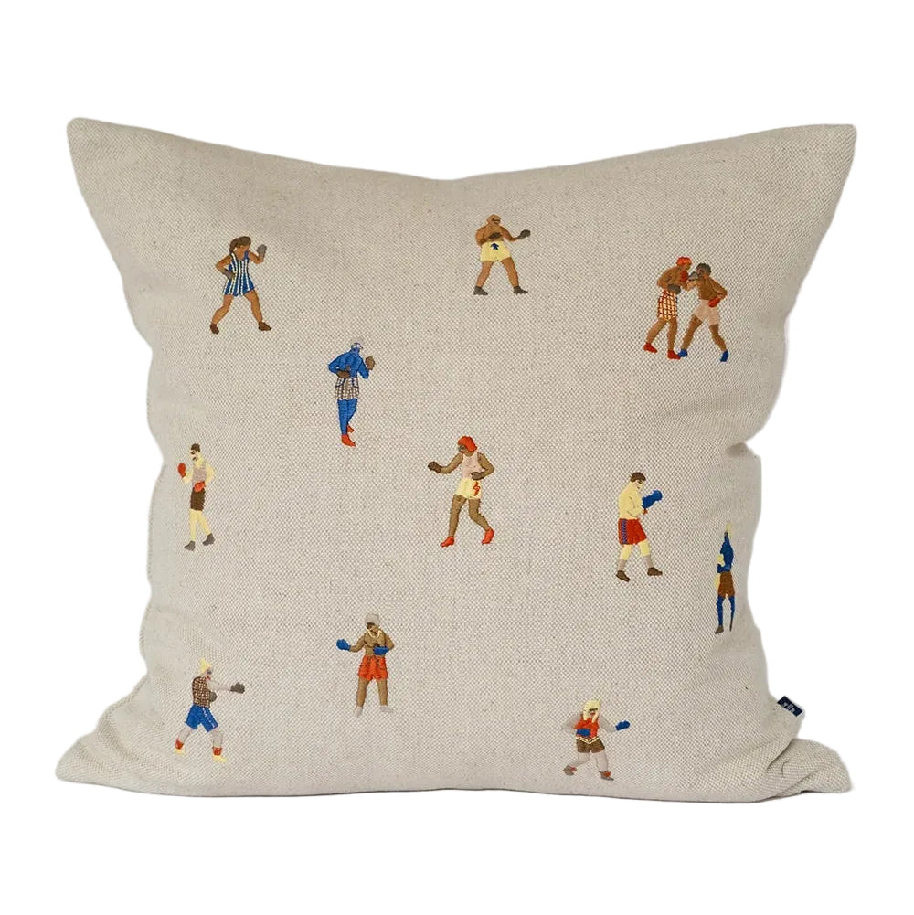Decorative pillow with embroidered figures on a plain background