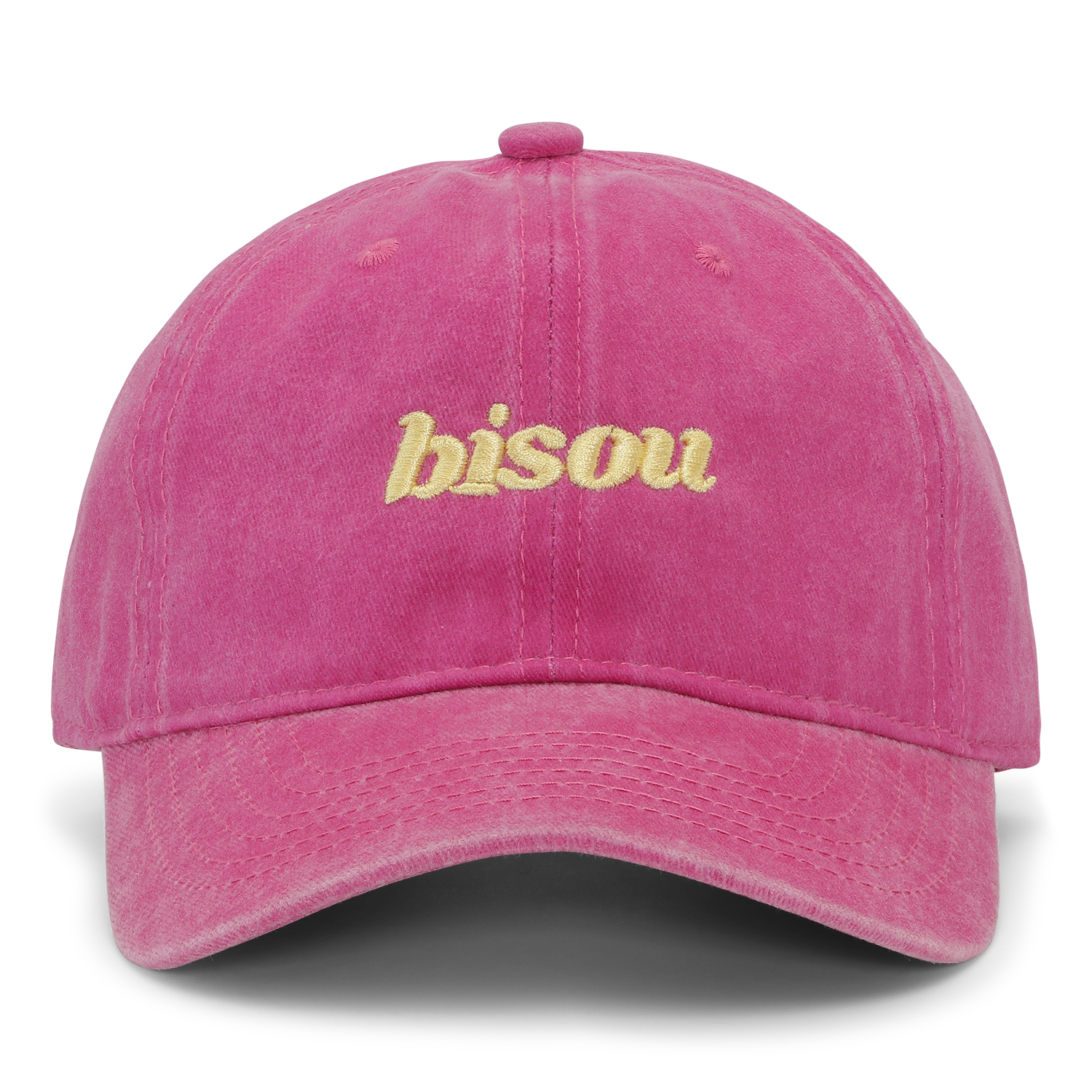 The Sui Ava Everyday Cap, Bisou in Pink, is a bright cotton cap with "bisou" embroidered in yellow on the front and an adjustable strap, shown against a plain white background.