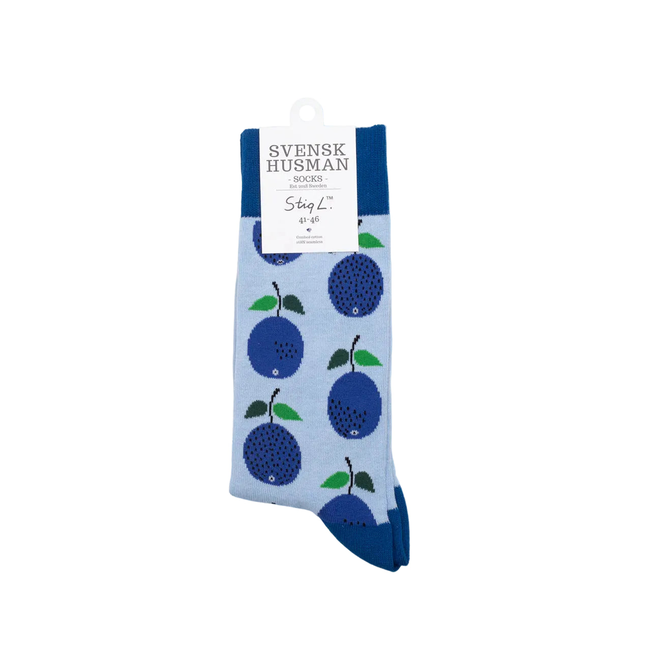 Socks, Stig L Prunus by Svensk Husman Socks: light blue socks inspired by Swedish design, with blue plums, green leaves, and dark blue cuff, heel, and toe accents. Folded and labeled for a stylish finish.