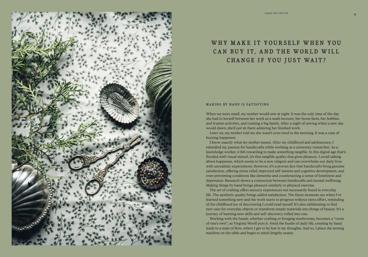 A flat lay featuring vintage baking tools, scissors, beads, and greenery artfully arranged on a textured surface beside an open page from “I Made This for You – Christmas Gift and Decorations Crafted with Love” by Cozy Publishing—an ideal source of inspiration for creating handmade decorations or heartfelt Christmas gifts.