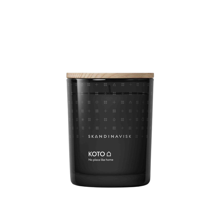 Black candle with wooden lid and Skandinavisk branding on a white background