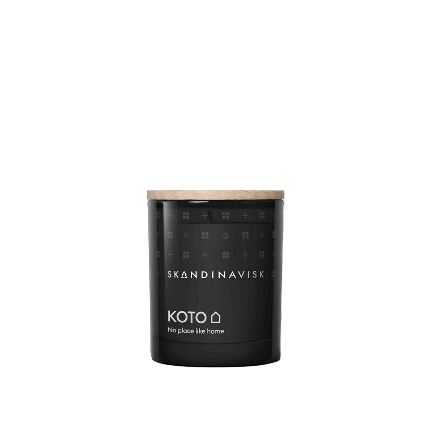 Black candle with wooden lid and Skandinavisk branding on a white background