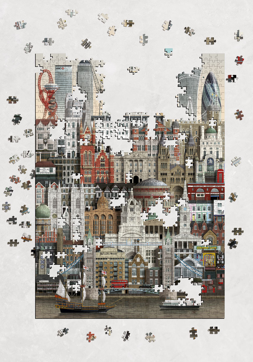 The Martin Schwartz London City Puzzle, a 1000-piece illustrated jigsaw, is partially assembled to reveal a vibrant cityscape of London’s iconic buildings, with loose puzzle pieces scattered around on a neutral surface.