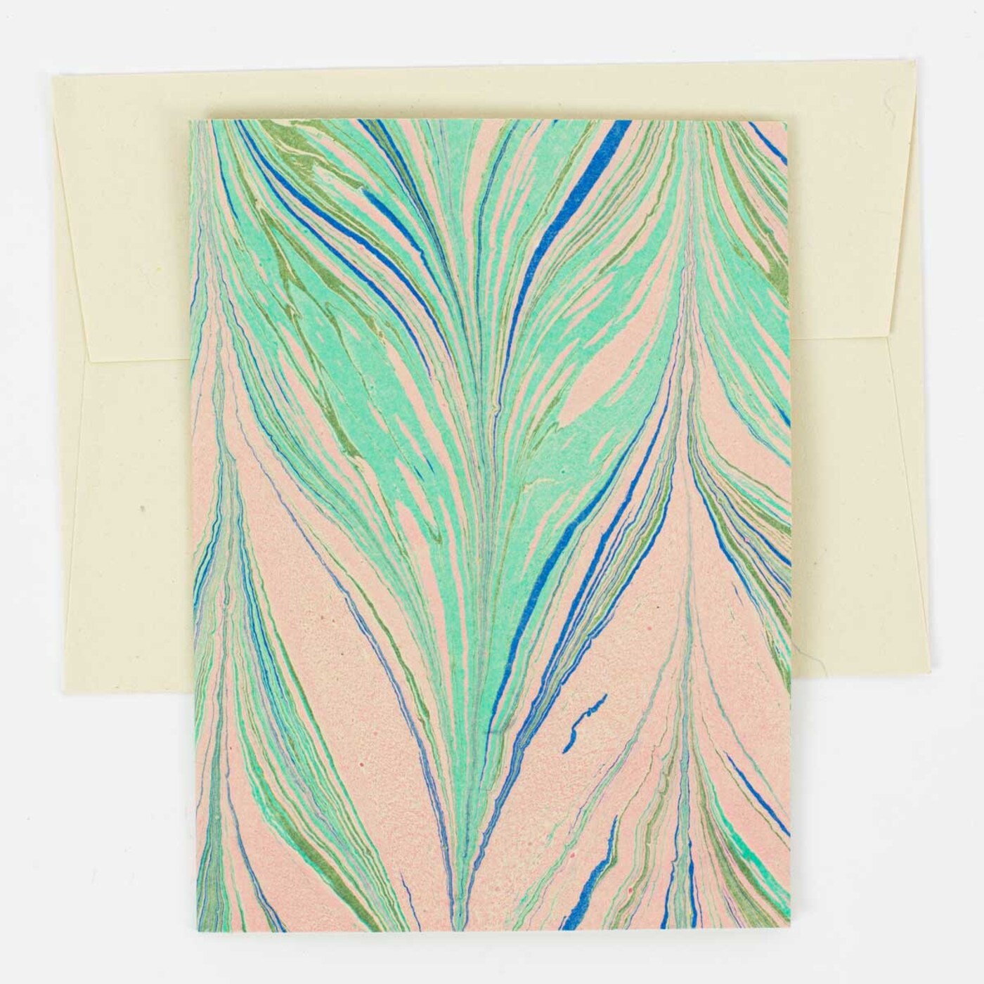 The A World of Craft Greeting Card Marble, Handmade features a marbled green, blue, and pink design atop a cream envelope, shown on a plain white background.