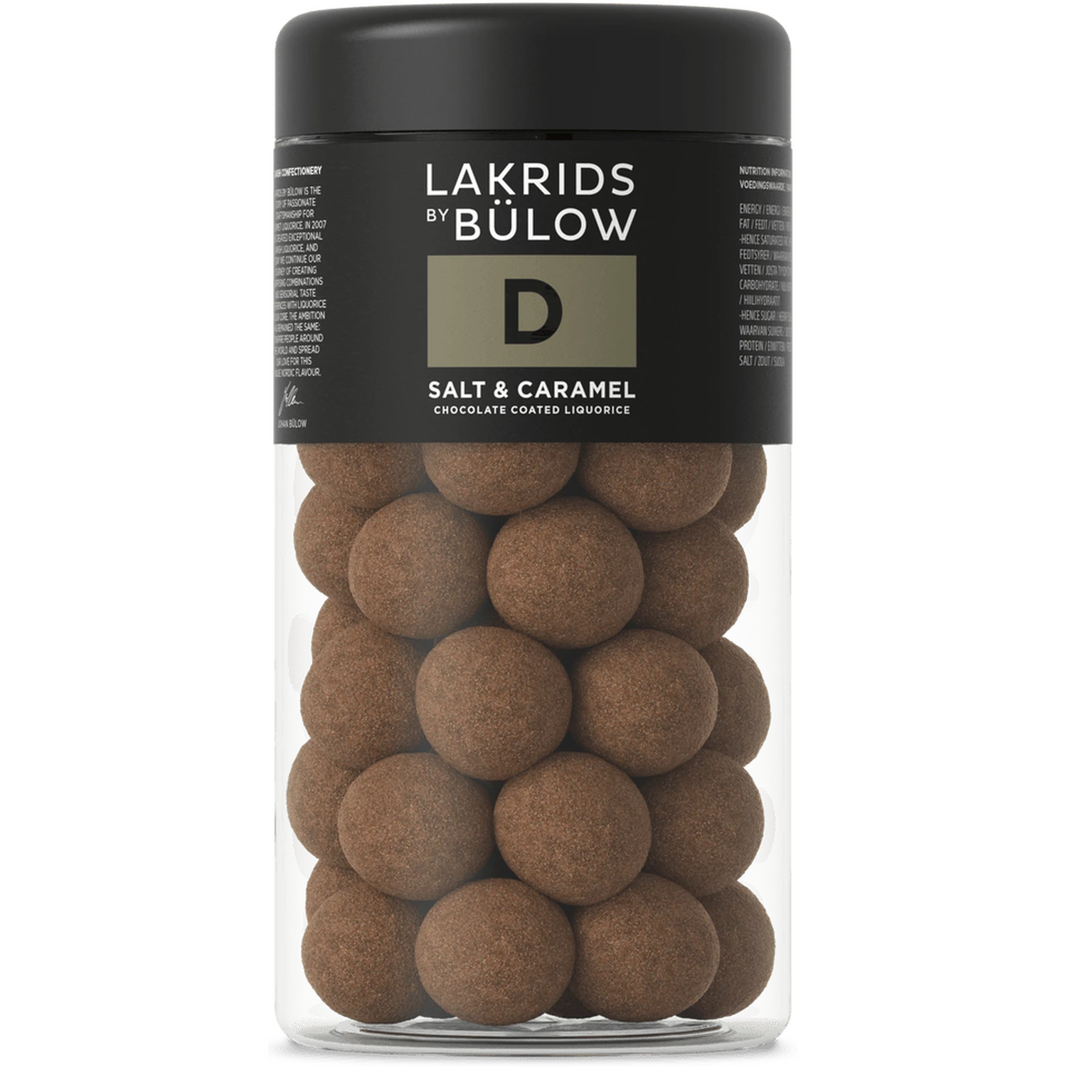 A clear jar with a black lid contains round, chocolate-coated liquorice balls. The label displays Lakrids by Bülow Salt & Caramel Liqourice, Regular, D—featuring sweet and salted caramel liquorice enrobed in decadent dulce chocolate.