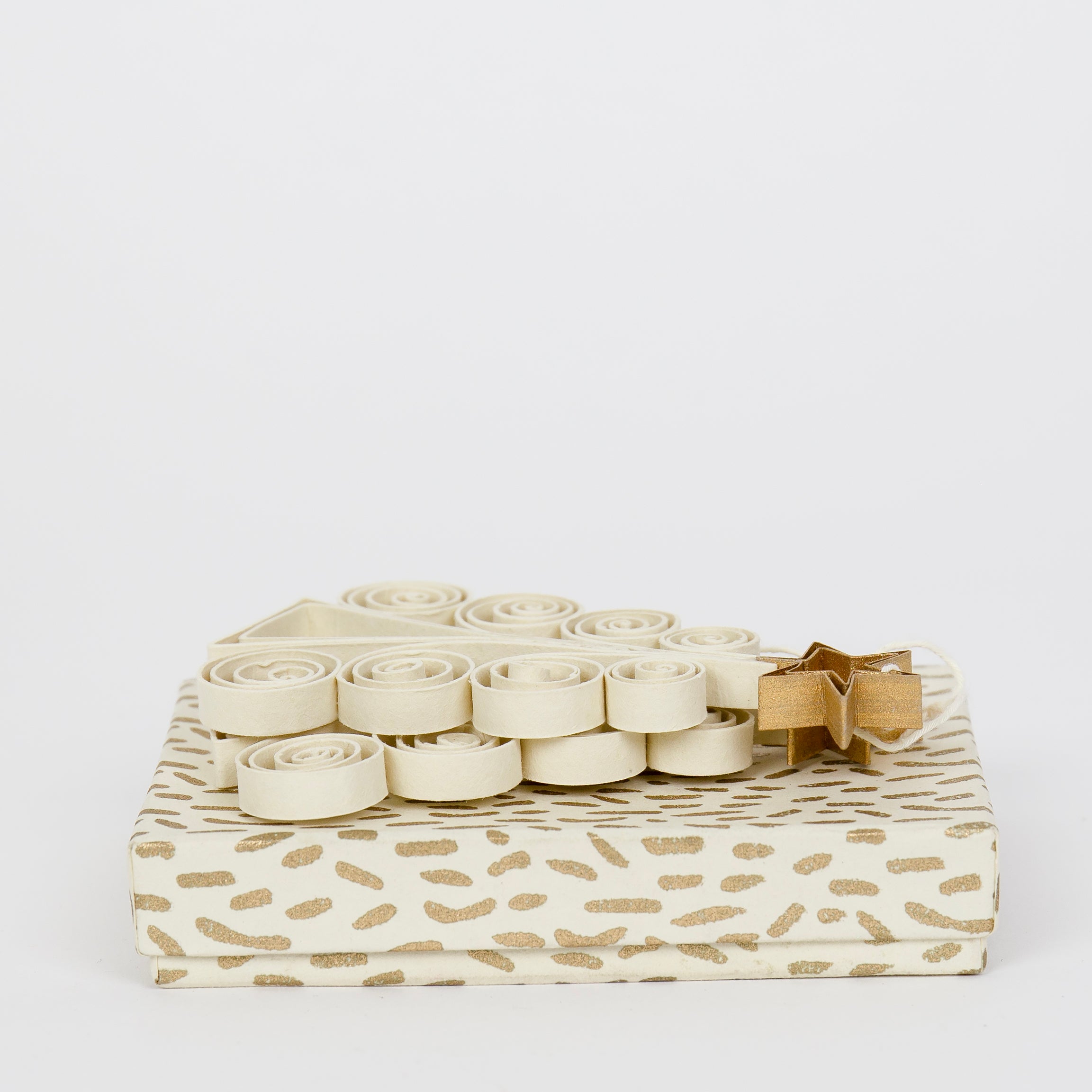 A World of Craft's Quilled Fir Tree Christmas Ornaments, 2 Pack in Beige and Gold, are beautifully wrapped with gold patterns and a spiral ribbon bow, displayed against a plain white background.
