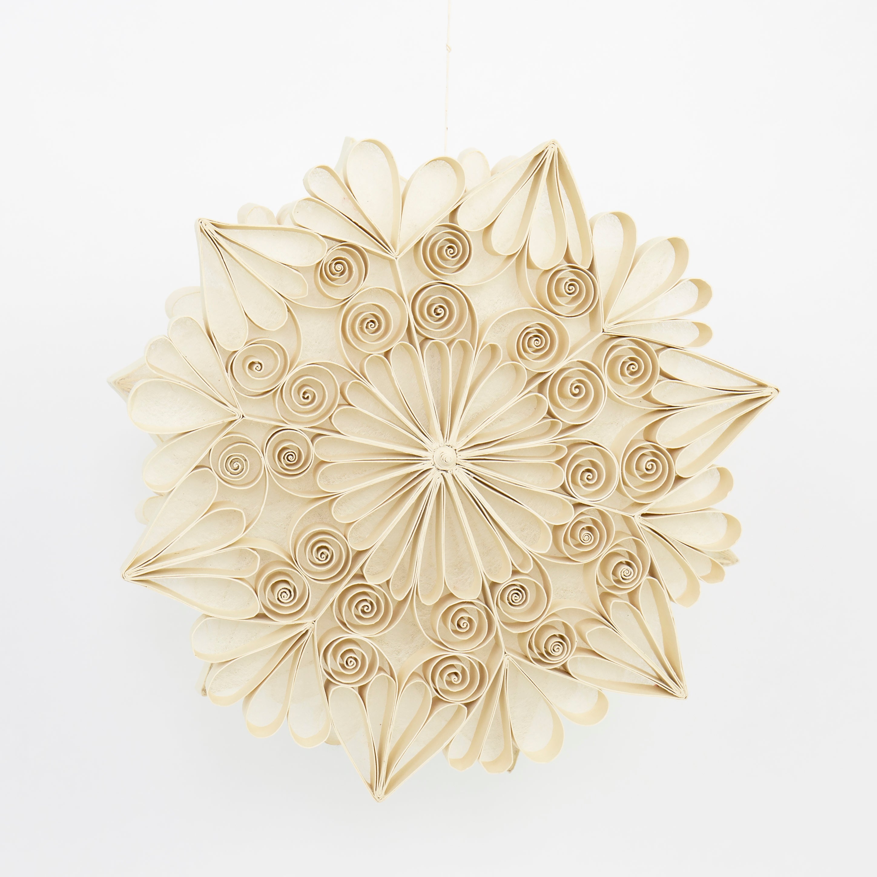 The Quilled Snowflake Christmas Ornament in Paper, Large by A World of Craft is a handmade, eco-friendly decoration featuring beige quilled spirals and petals in a star shape, perfect for adding elegance to your festive décor.