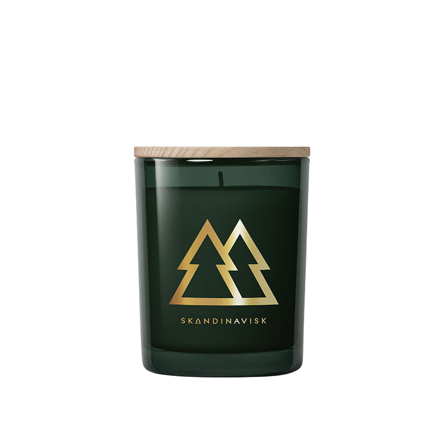 The Skandinavisk Seasonal Skog Gold Scented Candle (200g, 50h) comes in a dark green glass jar with wooden lid, features gold intersecting trees and SKANDINAVISK branding, and offers a subtle pine needle fragrance.
