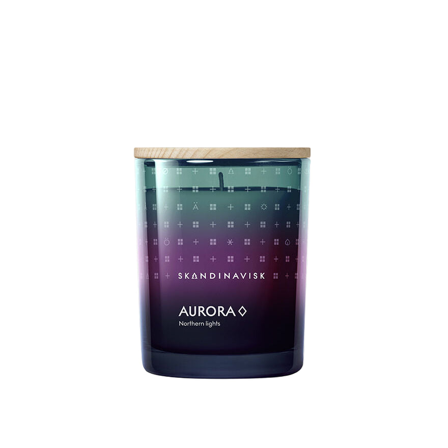 The Skandinavisk Seasonal Aurora Scented Candle (200g, 50h) features a gradient glass jar with a wooden lid, crafted from Swedish rapeseed wax, and offers a sandalwood and juniper berry scent.
