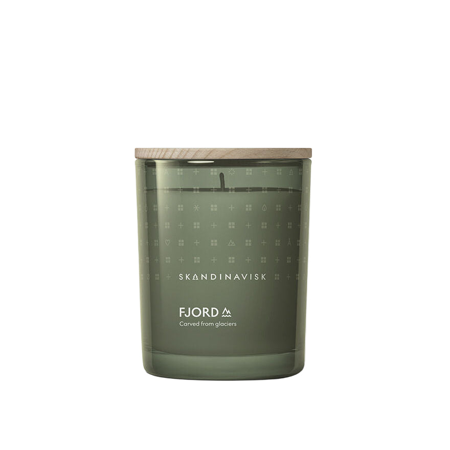 A green glass candle labeled "Skandinavisk Fjord," crafted from Swedish rapeseed wax with a wooden lid; 200g, 50h burn time.