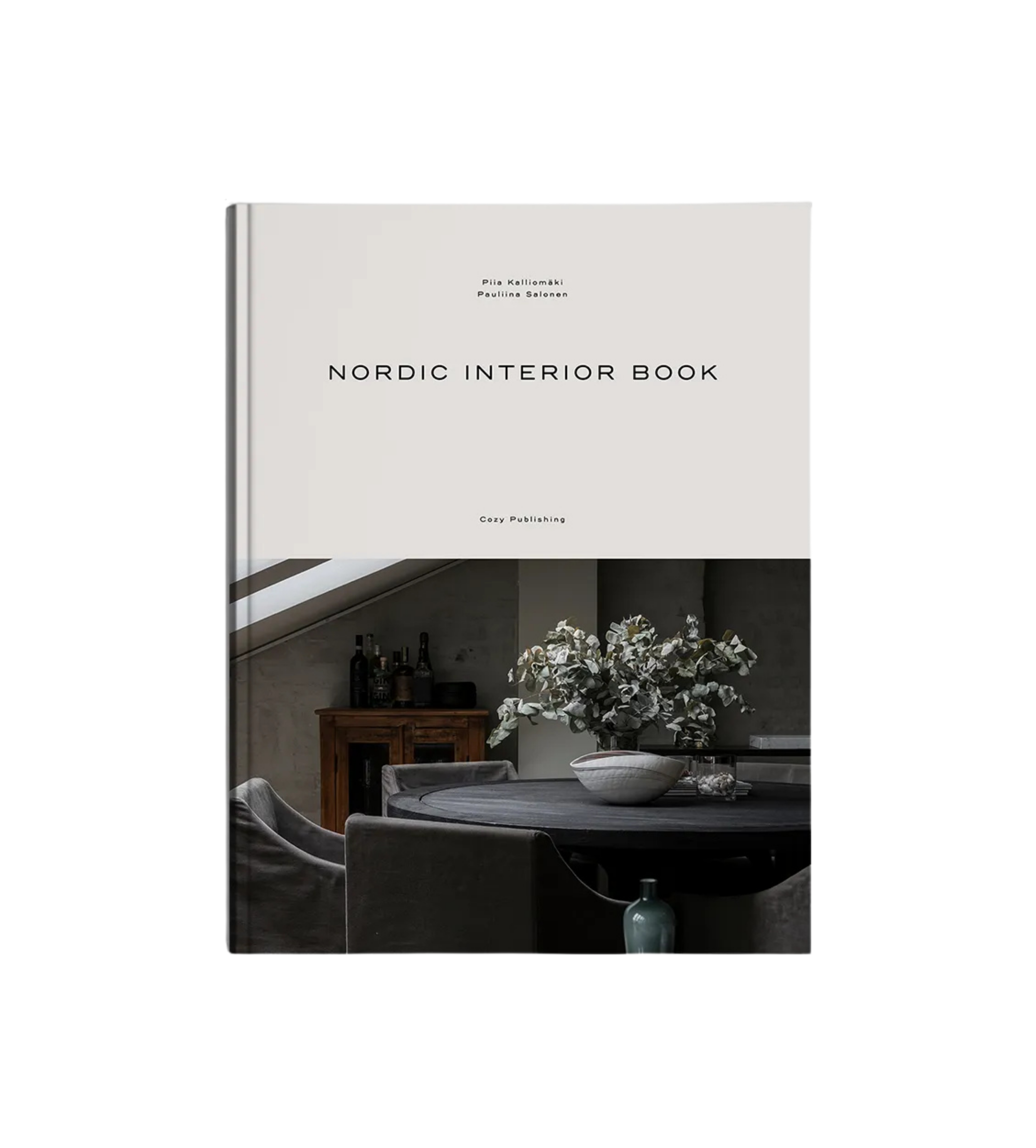 Nordic Interior Book by Cozy Publishing features a minimalist cover with a Finnish-inspired dining space—round table, floral accents, wooden cabinet, and soft neutral tones—ideal for fans of Nordic home design.