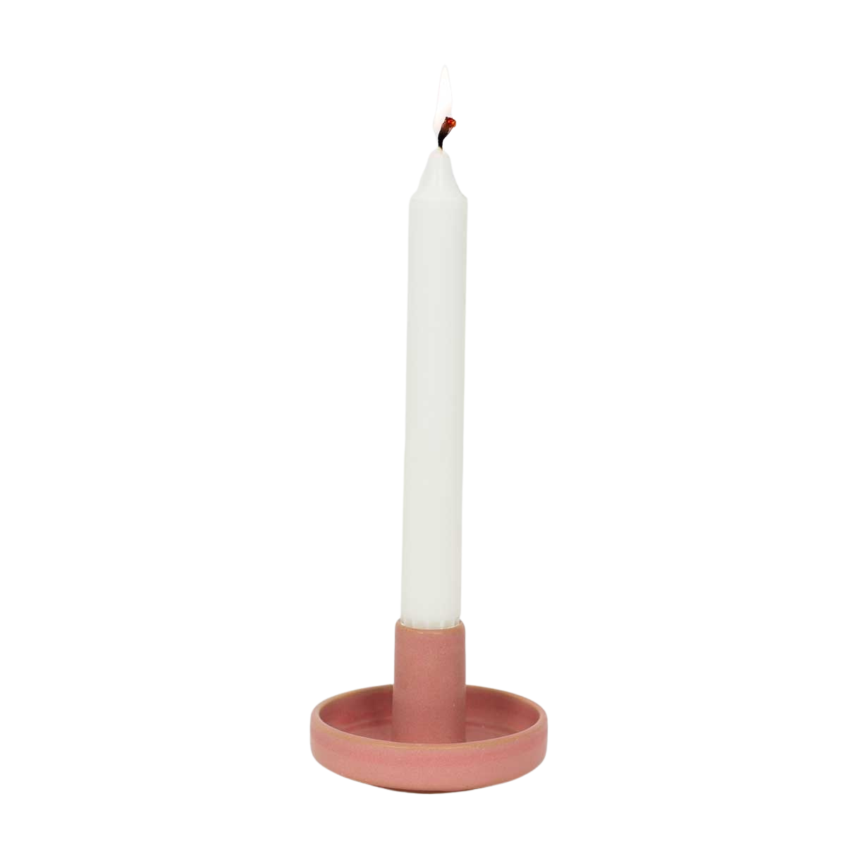 A white taper candle sits in the Hermes Handmade in Pink candle holder by A World of Craft, set against a plain light gray background.
