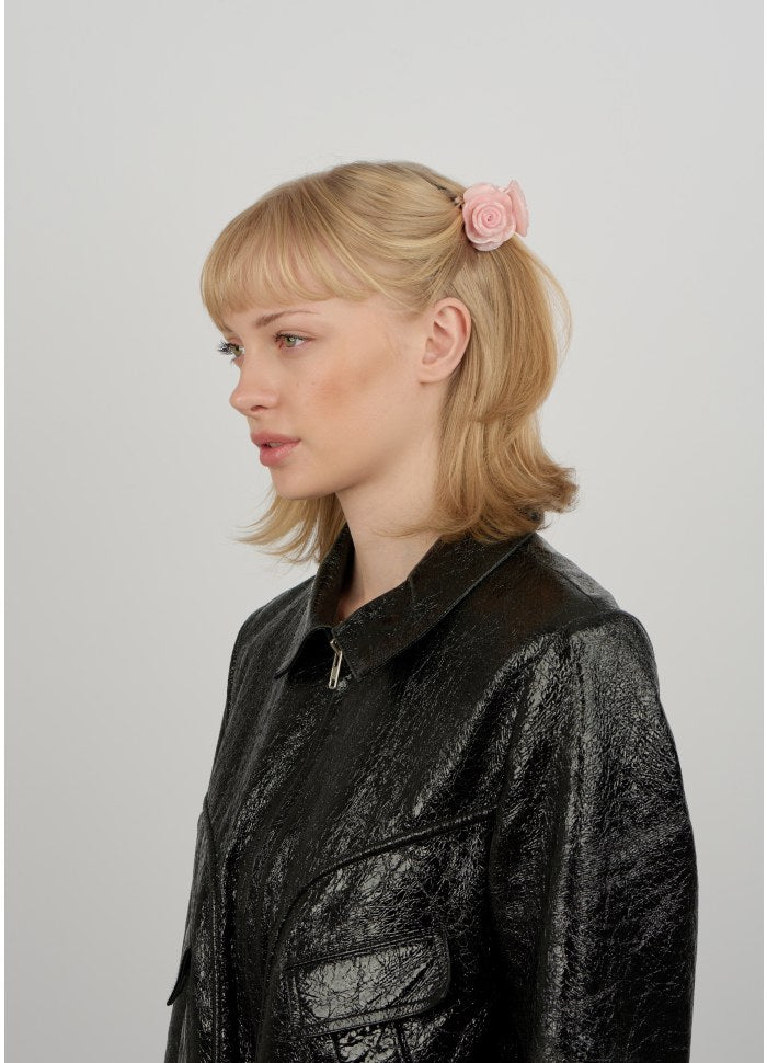 Profile view of a person wearing a millennial pink Rosie Mini Hair Claw in their hair.