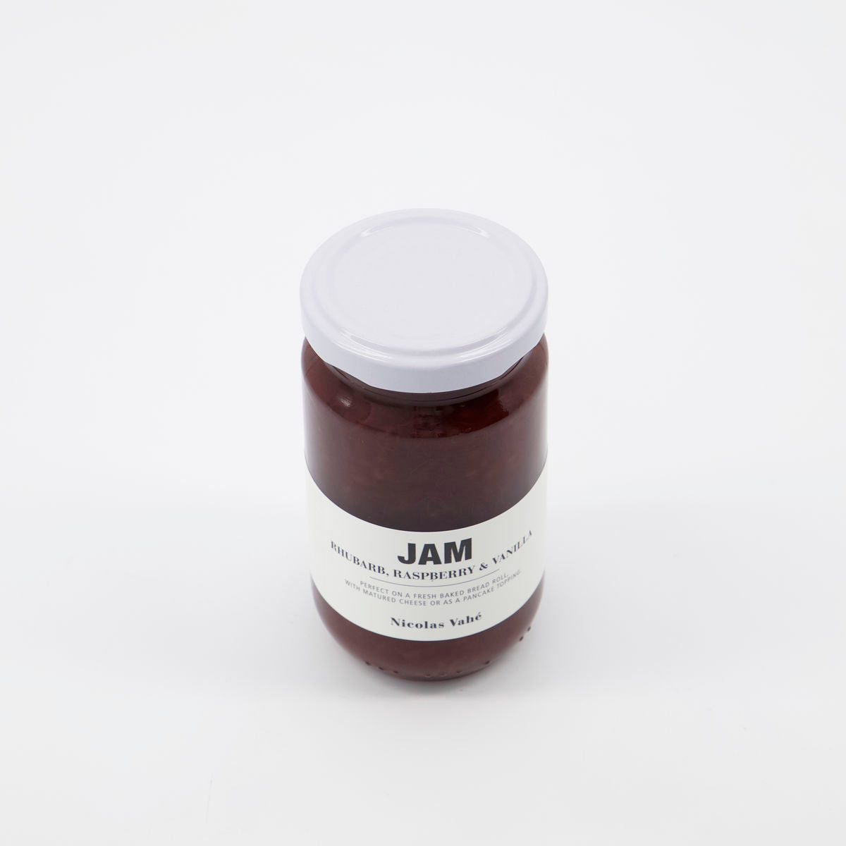 A jar of Nicolas Vahé Jam, Rhubarb, Raspberry & Vanilla rests on a white background, highlighting its flavorful blend of rhubarb and raspberry with a hint of vanilla.