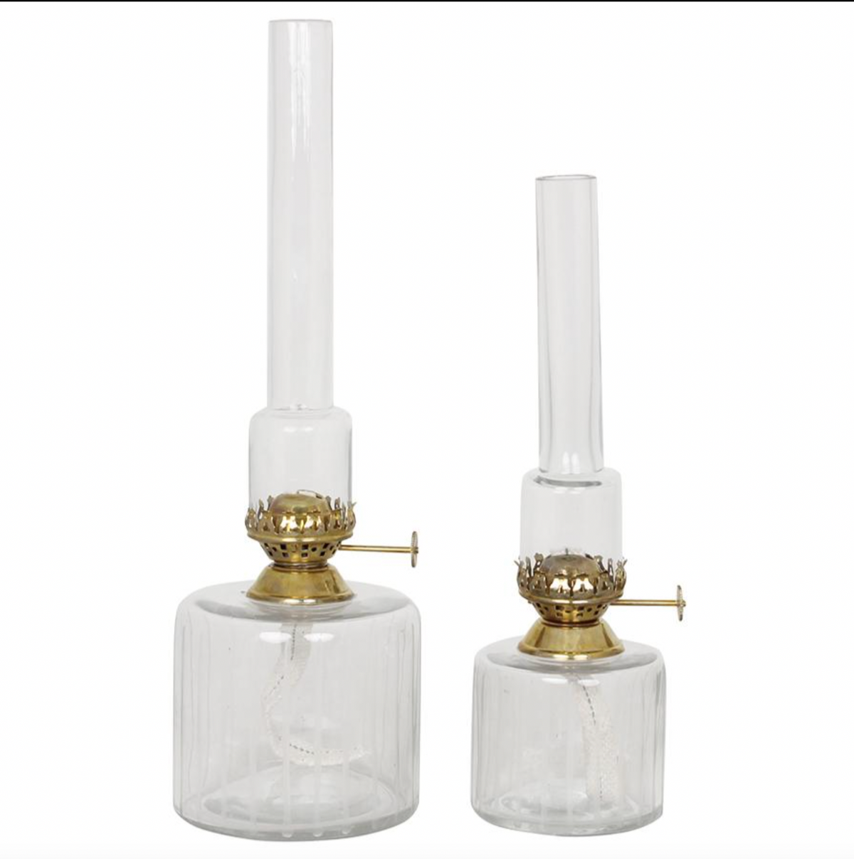 Two Elisabeth Oil Lamps in clear glass with brass burners, crafted by Strömshaga—one measuring 25cm and the other slightly taller—stand side by side on a plain white background.