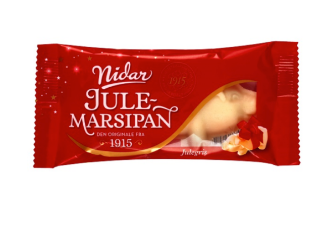 A red wrapper of Deli Nidar Liten Julegris (Small Marzipan Pig), 65 g, a Norwegian holiday marzipan treat with festive decor and a partial view of the marzipan pig.