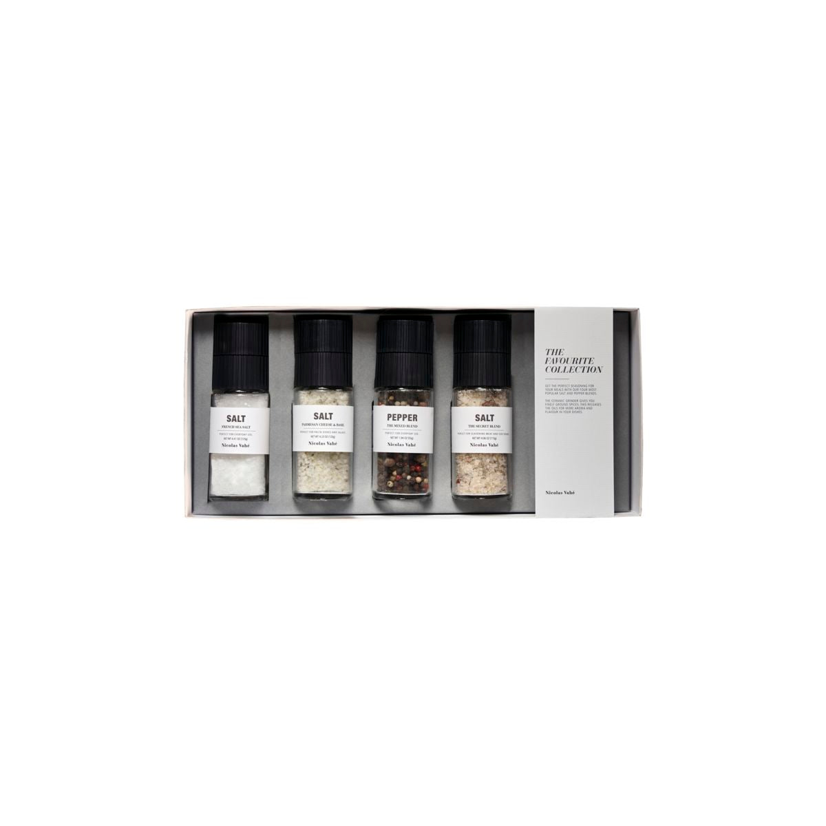 The Nicolas Vahe Gift Box includes four labeled spice grinders—French Sea Salt, Parmesan Cheese & Basil Salt, The Secret Blend Salt, and Mixed Pepper—making it the perfect gift for gourmet seasoning lovers.